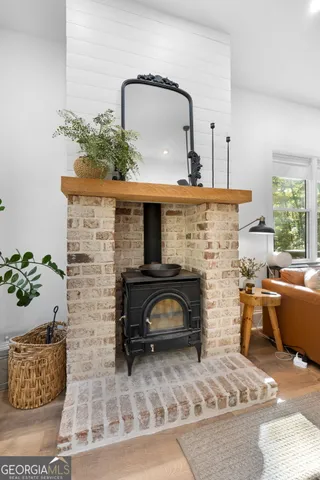 a living room with furniture and potted plants
