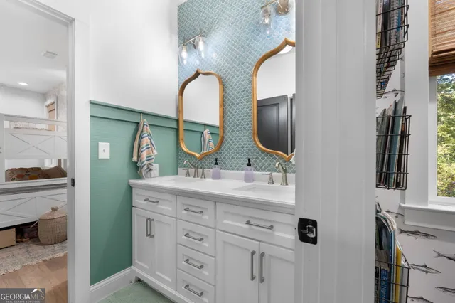 a bathroom with a double vanity sink and a mirror