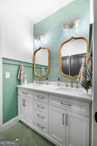 a bathroom with 2 sink and a mirror