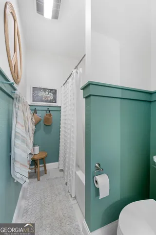 a bathroom with a toilet and a vanity