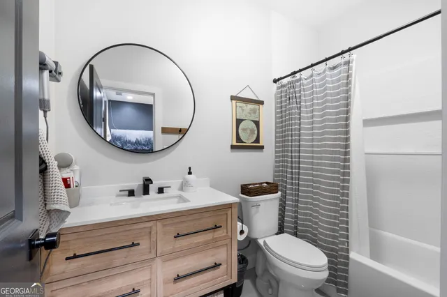 a bathroom with a toilet a sink and a mirror
