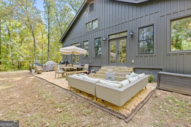 a living room with patio furniture and a fireplace