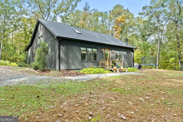 a view of a house with backyard and sitting area