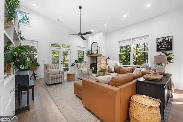 a living room with furniture a window and a chandelier