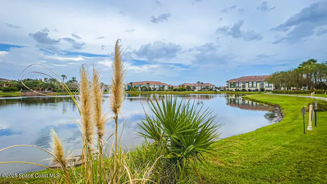 a view of a lake with houses in the back