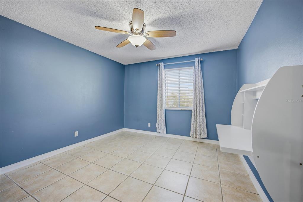 6519 West Newberry Road, Unit 109 Gainesville, FL 32605 - Photo 11 of 21 a view of an empty room with a chandelier fan