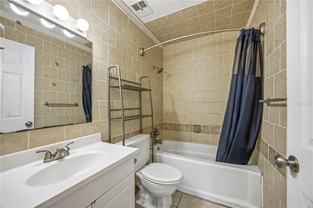 6519 West Newberry Road, Unit 109 Gainesville, FL 32605 - Photo 16 of 21 a bathroom with a sink toilet and shower