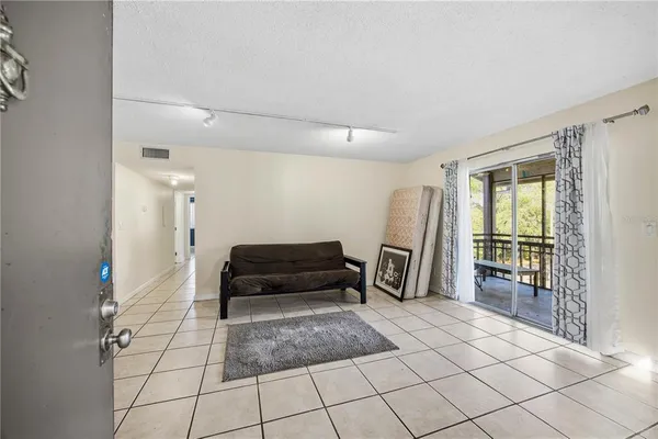 a living room with a large mirror next to a window