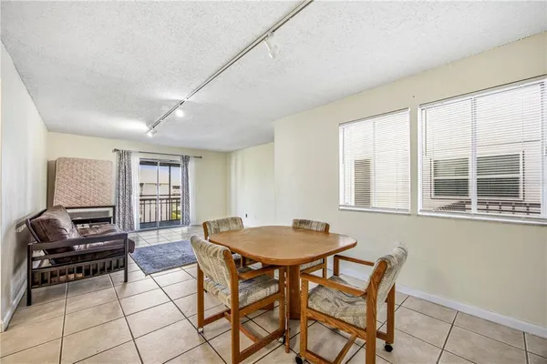 a view of a dining room with furniture and a window