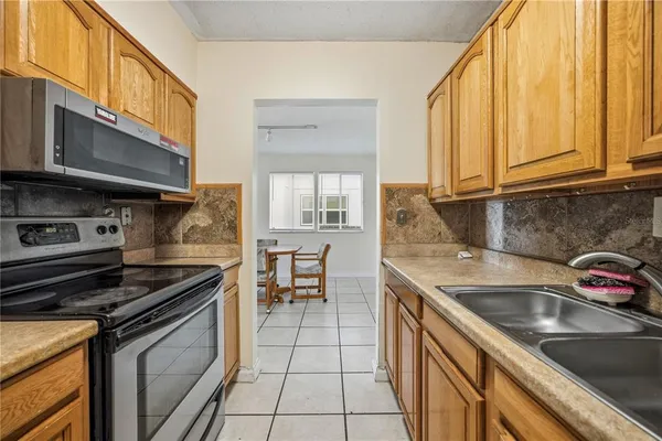 a kitchen that has a sink and a stove