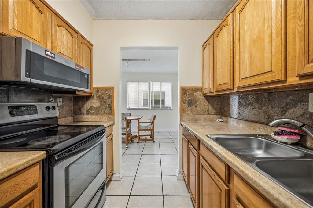 6519 West Newberry Road, Unit 109 Gainesville, FL 32605 - Photo 10 of 21 a kitchen that has a sink and a stove