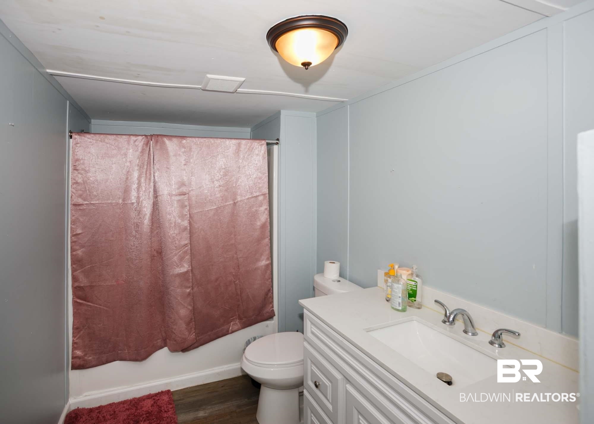 11998 Workman Avenue Foley, AL 36535 - Photo 24 of 59 Full bathroom with wood finished floors, shower / tub combo with curtain, and vanity