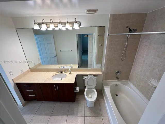 a bathroom with a tub a sink and mirrors