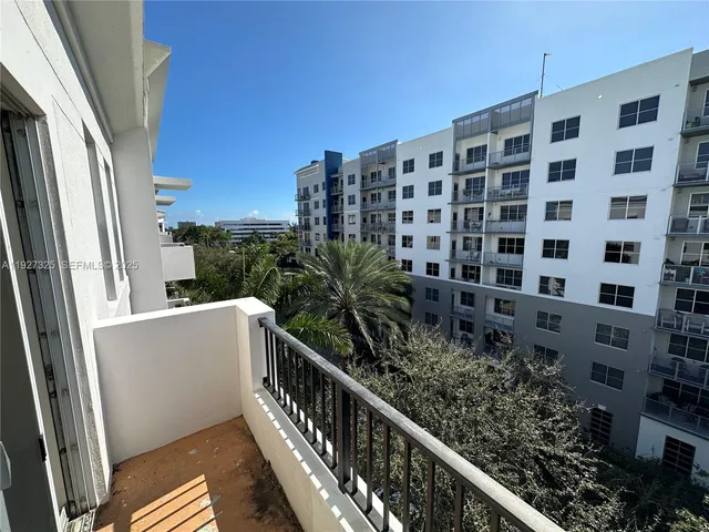 a view of a balcony with wooden floor and fence