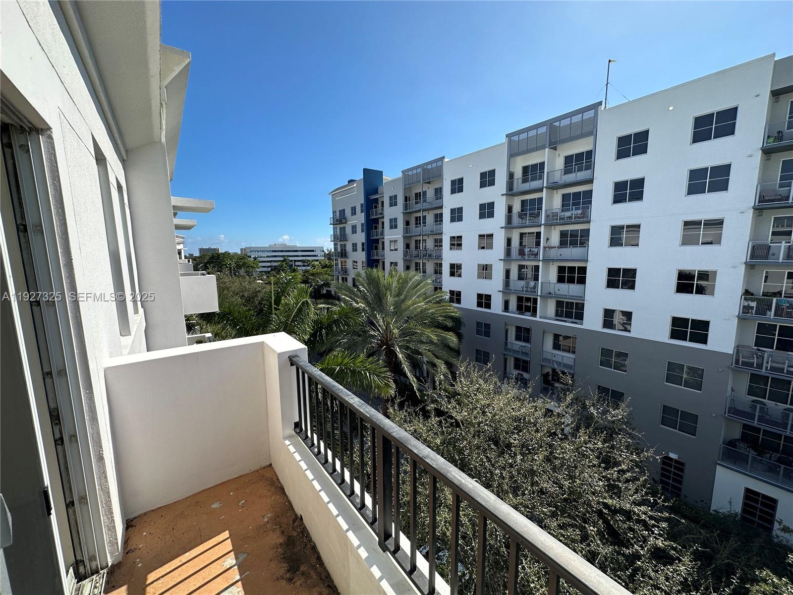2401 Northeast 65th Street, Unit 606 Fort Lauderdale, FL 33308 - Photo 17 of 19 a view of a balcony with wooden floor and fence