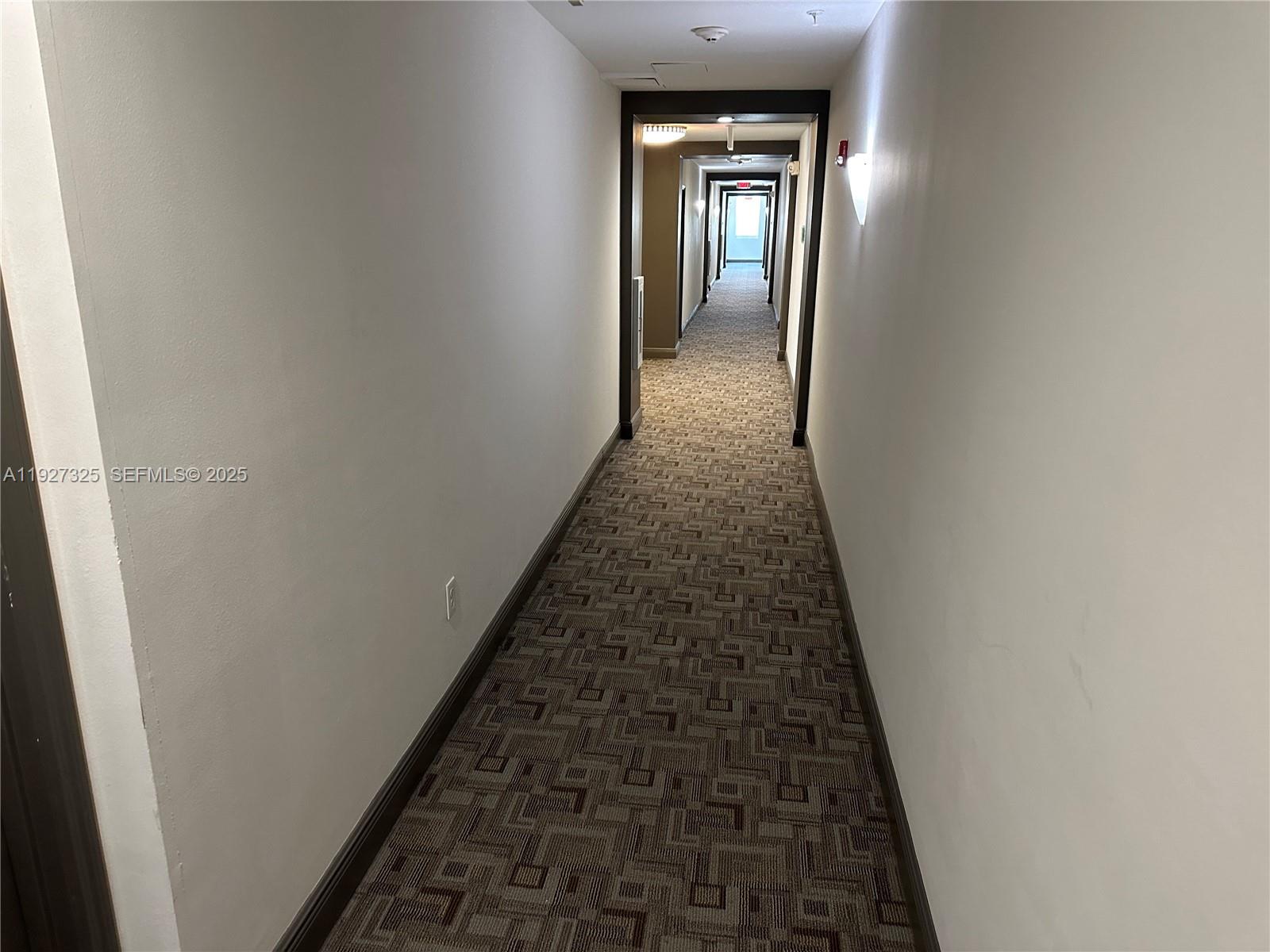 2401 Northeast 65th Street, Unit 606 Fort Lauderdale, FL 33308 - Photo 4 of 19 wooden floor with a hallway
