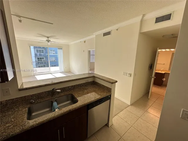 a kitchen with a sink stove and a refrigerator