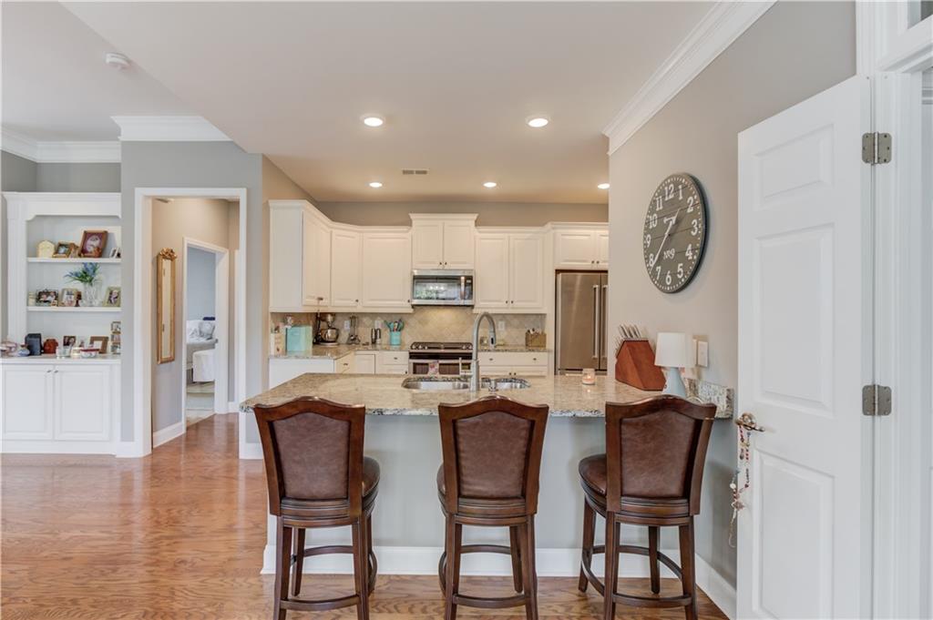3675 Ridgehurst Drive Buford, GA 30519 - Photo 16 of 43 a dining room with furniture and a clock