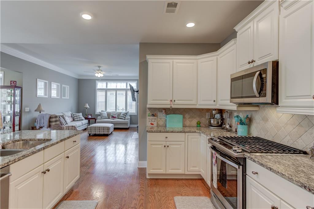 3675 Ridgehurst Drive Buford, GA 30519 - Photo 20 of 43 a kitchen with sink stove and cabinets