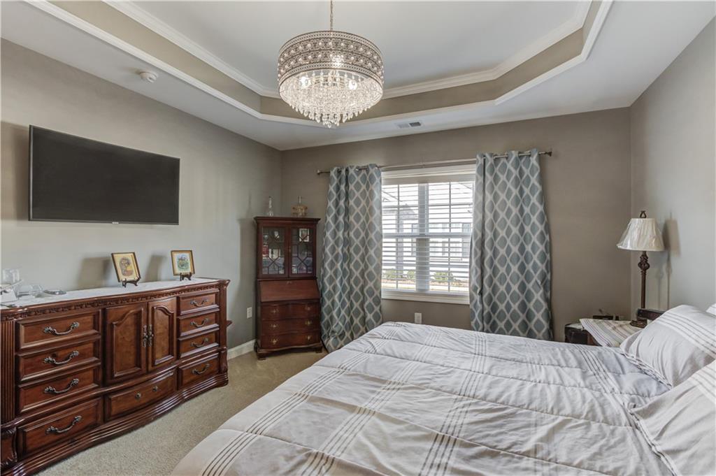 3675 Ridgehurst Drive Buford, GA 30519 - Photo 21 of 43 a bedroom with a bed and a flat screen tv