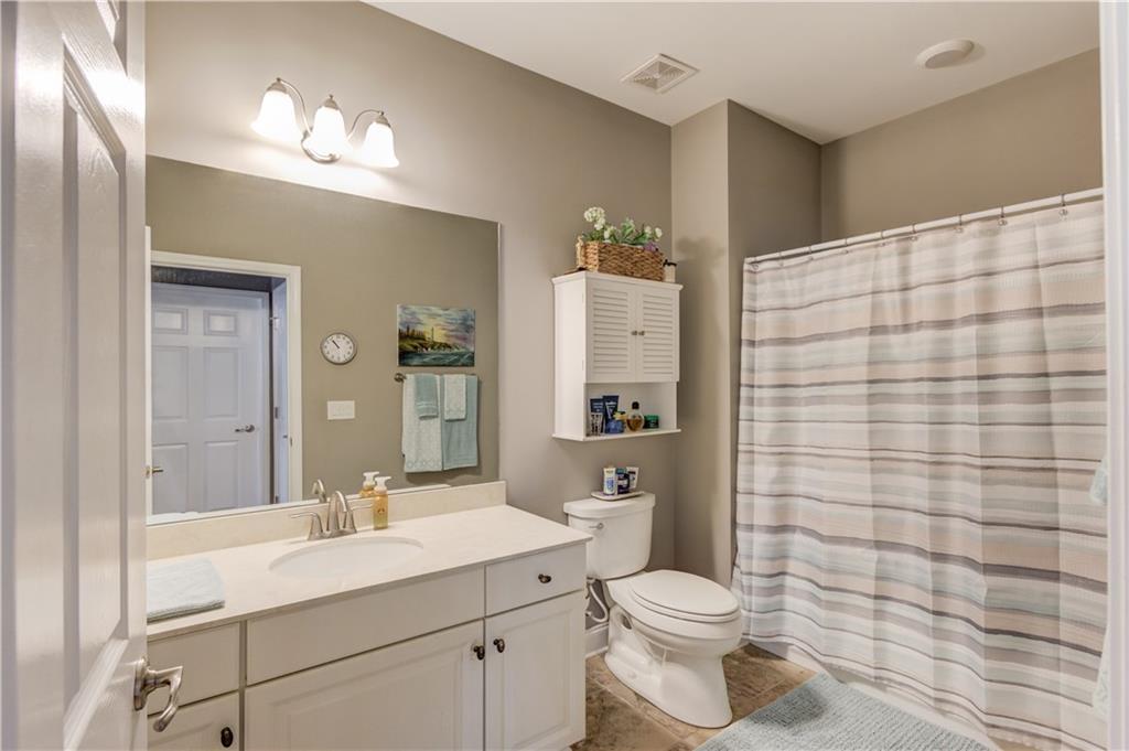 3675 Ridgehurst Drive Buford, GA 30519 - Photo 28 of 43 a bathroom with a sink a toilet and shower