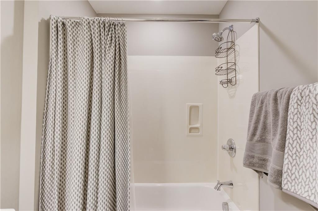 3675 Ridgehurst Drive Buford, GA 30519 - Photo 34 of 43 a bathroom with a shower curtain and a curtain