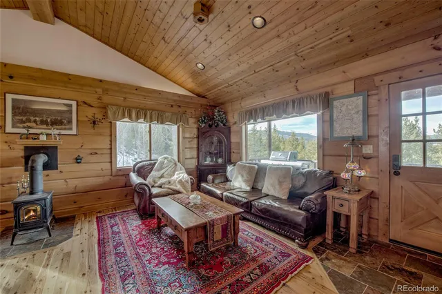 a living room with furniture a fireplace and a table