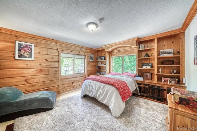 a bedroom with a bed furniture and a window
