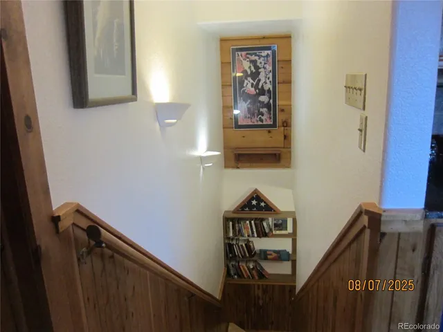 a view of a hallway with paintings on the wall