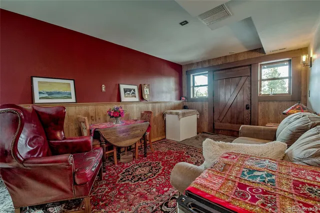 a living room with furniture rug and window
