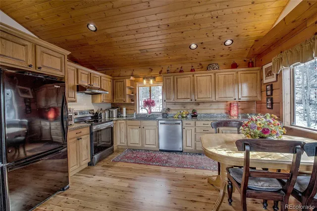 a kitchen with refrigerator and cabinets