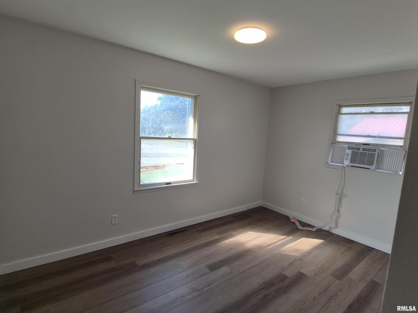 802 Dillard Street Eldorado, IL 62930 - Photo 13 of 24 an empty room with wooden floor and windows