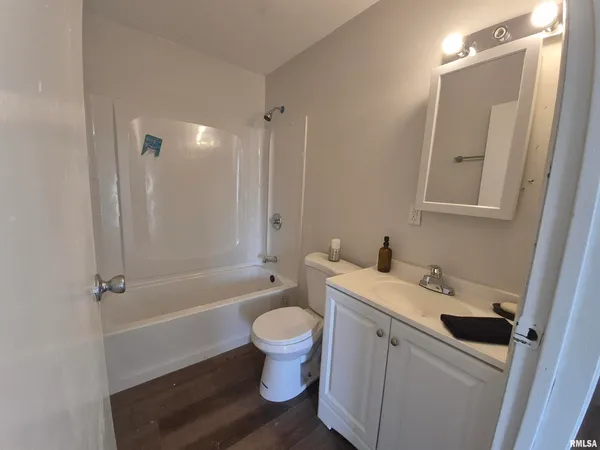 a bathroom with a sink toilet vanity and shower
