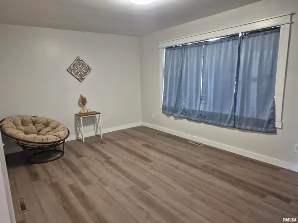 a view of a room with wooden floor and couch