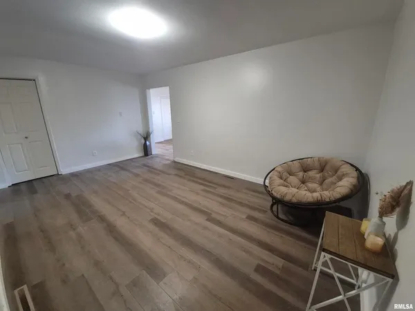 a view of a room with furniture and chandelier