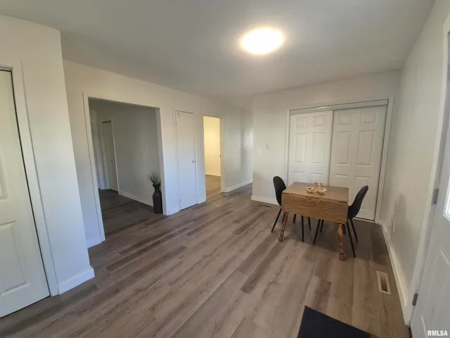 a view of a dining room with furniture and wooden floor