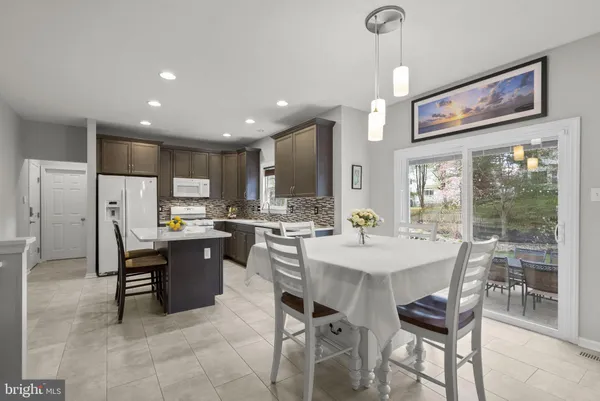 a kitchen with a stove a refrigerator and a sink