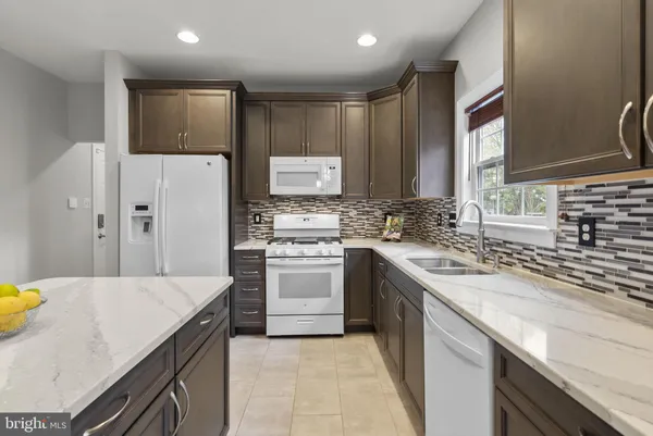 a kitchen that has a sink and a stove in it