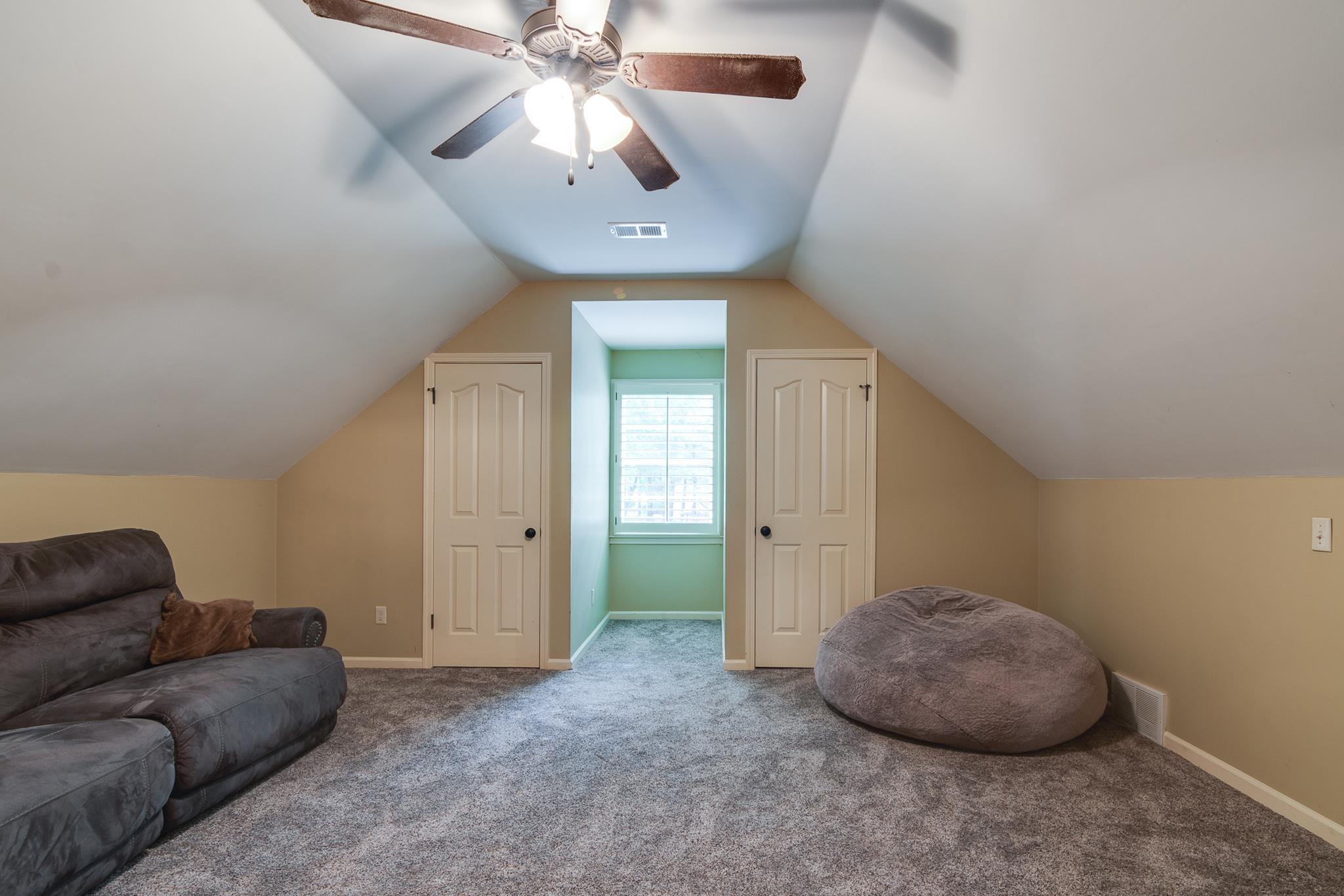 791 North Tree Drive Collierville, TN 38017 - Photo 21 of 27 Spacious bonus room featuring sloped ceilings, plush gray carpeting, a built-in window nook, and two paneled doors