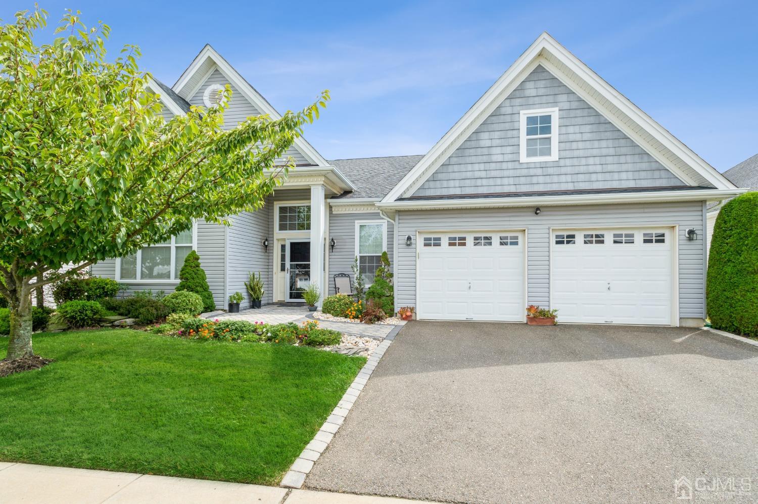 114 Riviera Drive Monroe Township, NJ 08831 - Photo 1 of 40 a front view of a house with a yard and garage