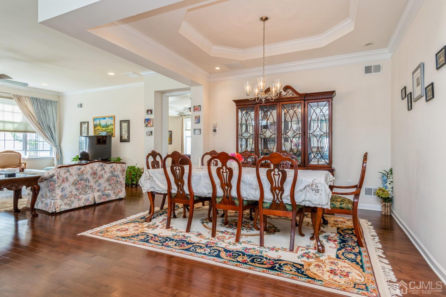114 Riviera Drive Monroe Township, NJ 08831 - Photo 12 of 40 a dining room with furniture a chandelier and wooden floor