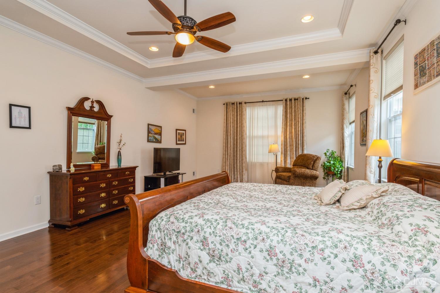 114 Riviera Drive Monroe Township, NJ 08831 - Photo 17 of 40 a bedroom with a bed dresser and wooden floor