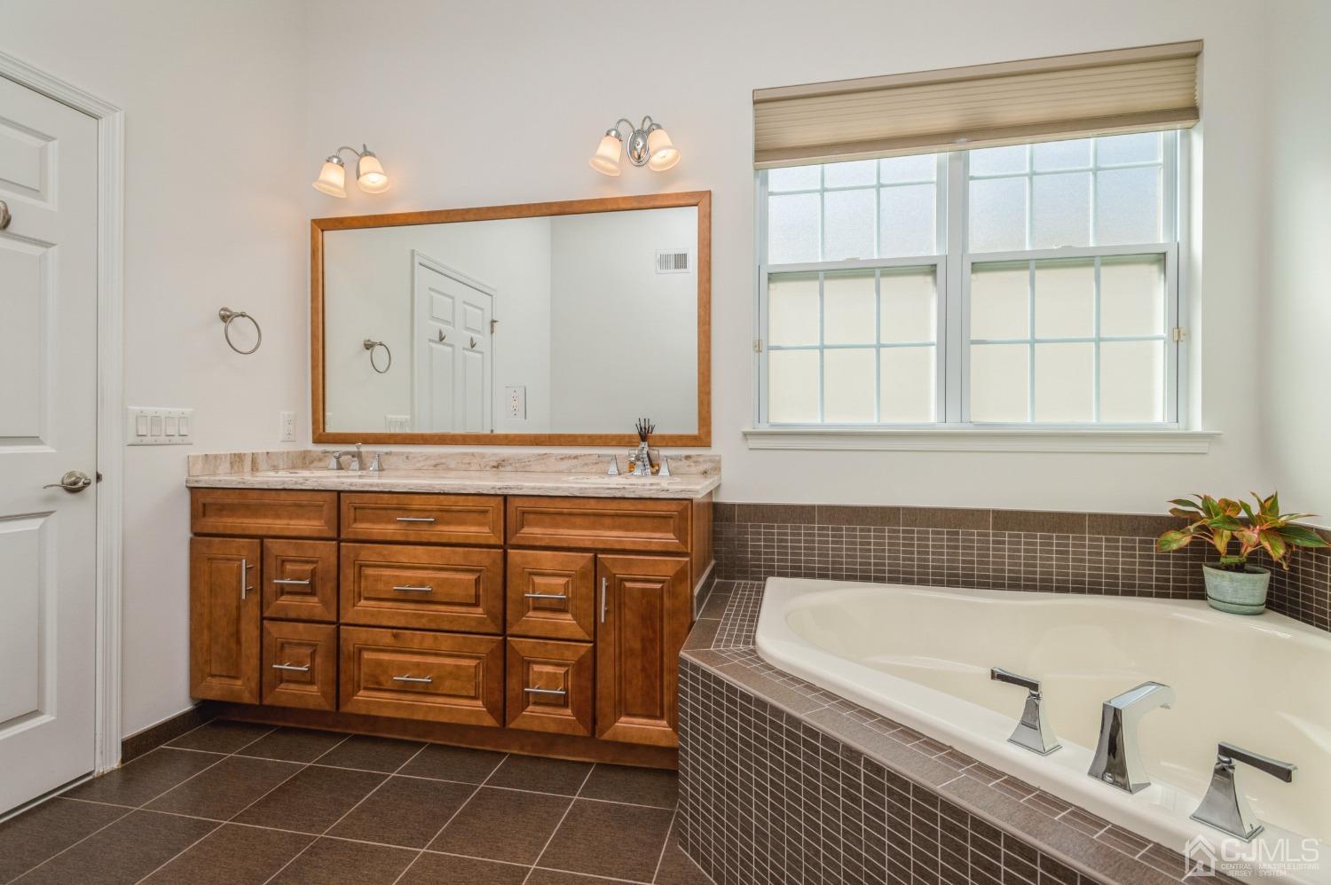 114 Riviera Drive Monroe Township, NJ 08831 - Photo 18 of 40 a bathroom with a tub a sink and a shower