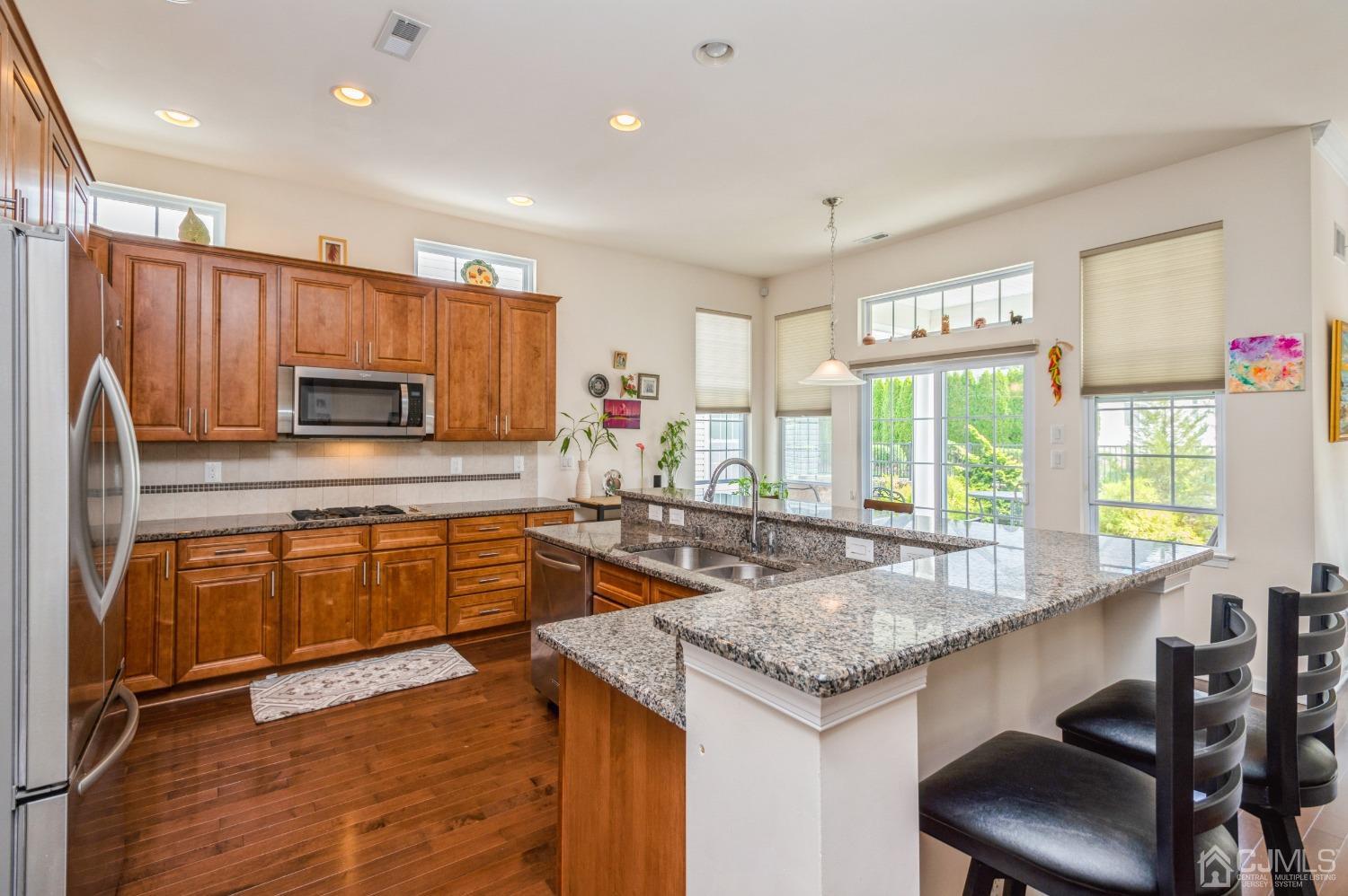 114 Riviera Drive Monroe Township, NJ 08831 - Photo 5 of 40 a kitchen with granite countertop a sink and counter space