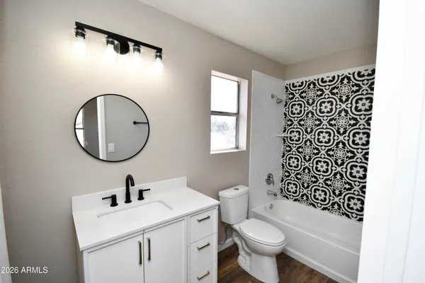 a bathroom with a sink a toilet and a mirror