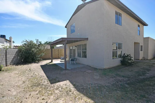 a view of a house with backyard and sitting area