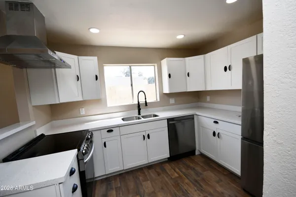 a kitchen with a sink stove and cabinets