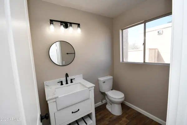 a bathroom with a toilet sink and mirror