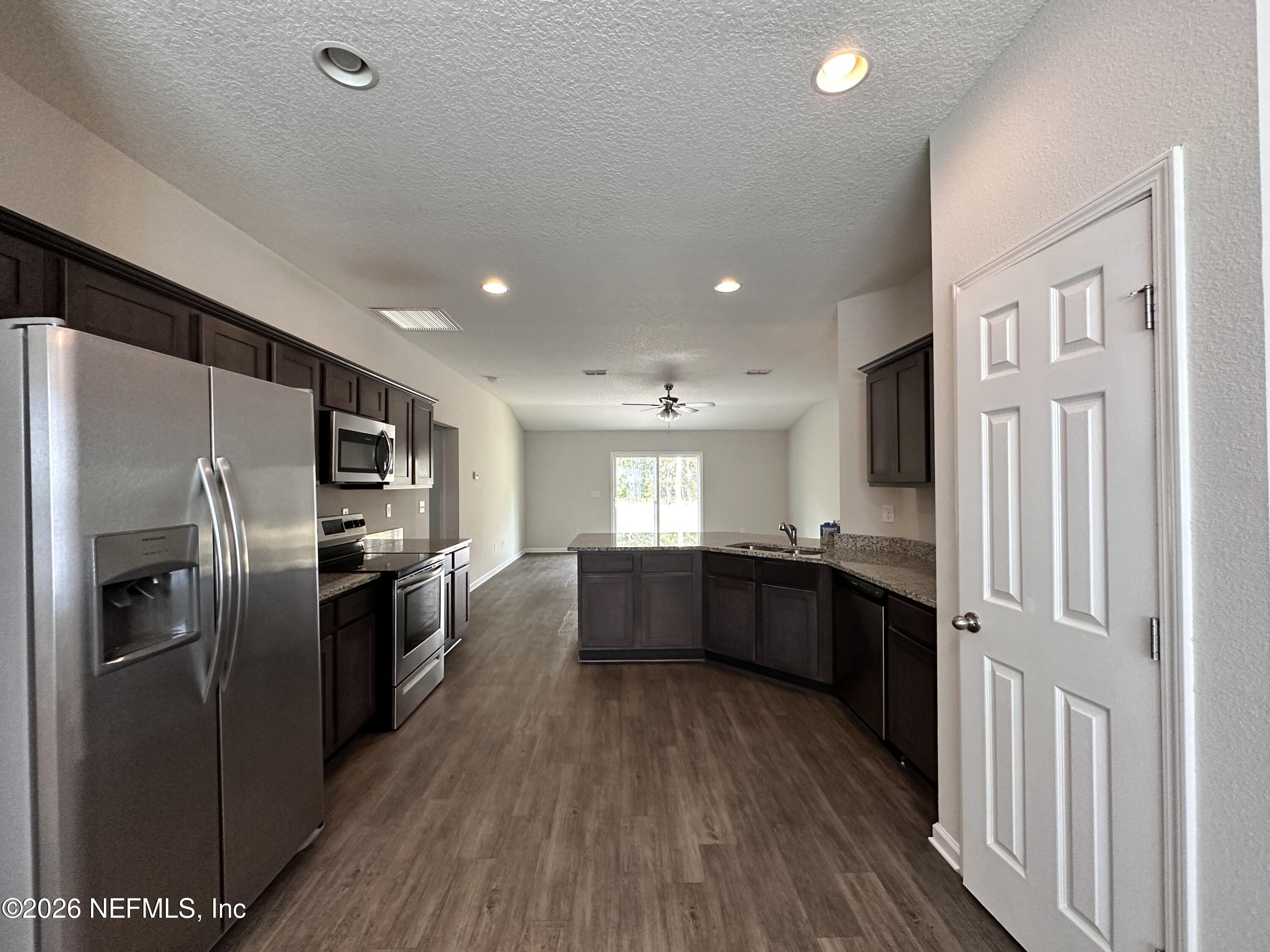 3460 Belfort Road Jacksonville, FL 32216 - Photo 3 of 16 a large kitchen with a lot of counter space stainless steel appliances