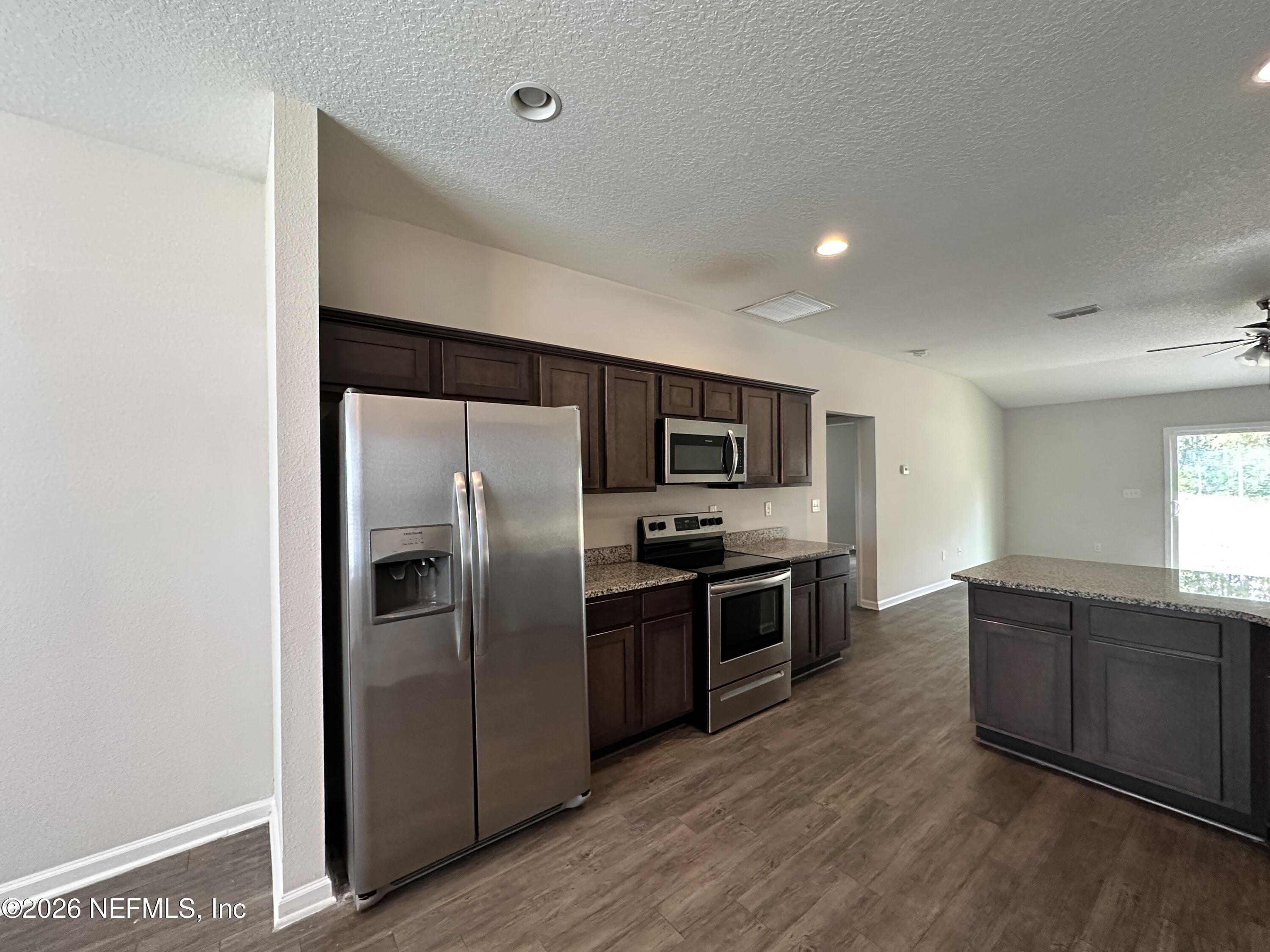 3460 Belfort Road Jacksonville, FL 32216 - Photo 4 of 16 a kitchen with stainless steel appliances granite countertop a refrigerator and a sink